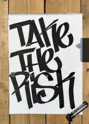 White poster with black marker graffiti tag, "Take the risk."