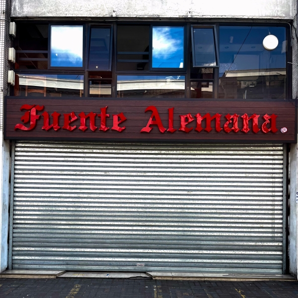 Fuente Alemana storefront, red text in a gothic typeface.