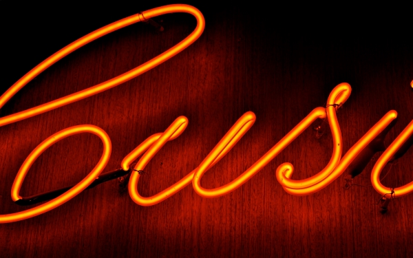 Red-orange neon sign in cursive