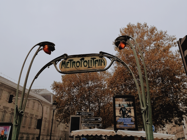 Metropolilitain Paris sign outside metro stop in fall.