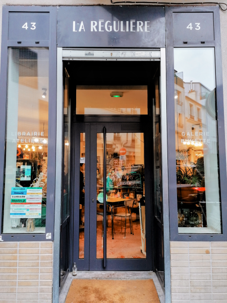 Outside a business in Paris. All caps white lettering on a black background: "LA REGULIERE."