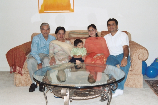 Photo of three generations of the Gulati family on the couch together