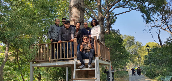 Neeraj and his colleagues in a tree stand in the woods