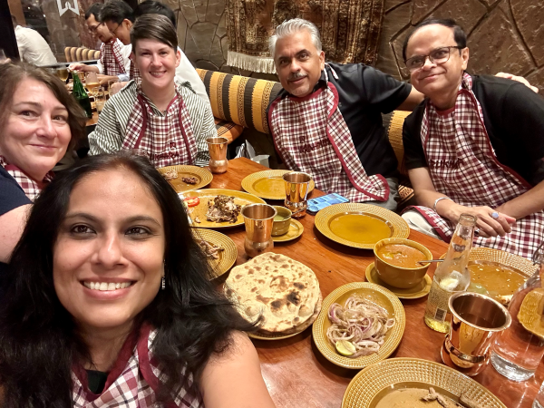 Neeraj and Monotype team sharing a meal, wearing matching bibs.