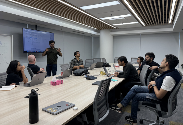 A group of people in an office meeting room brainstorming.