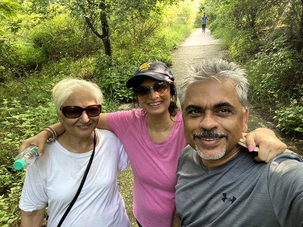 Neeraj (right) on a small group hike in the woods.