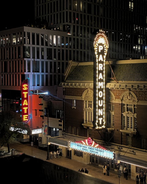 Neon lights on the street outside the State and Paramount Theaters.