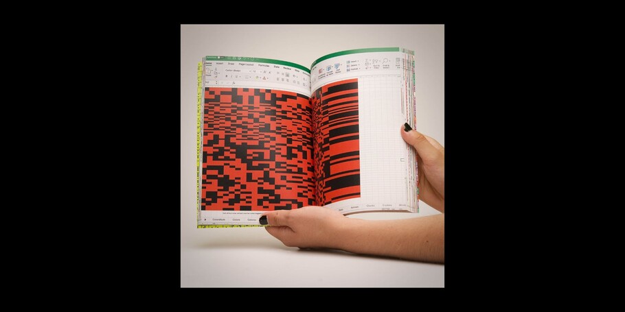 A hand holding a book with typography on it in red and black